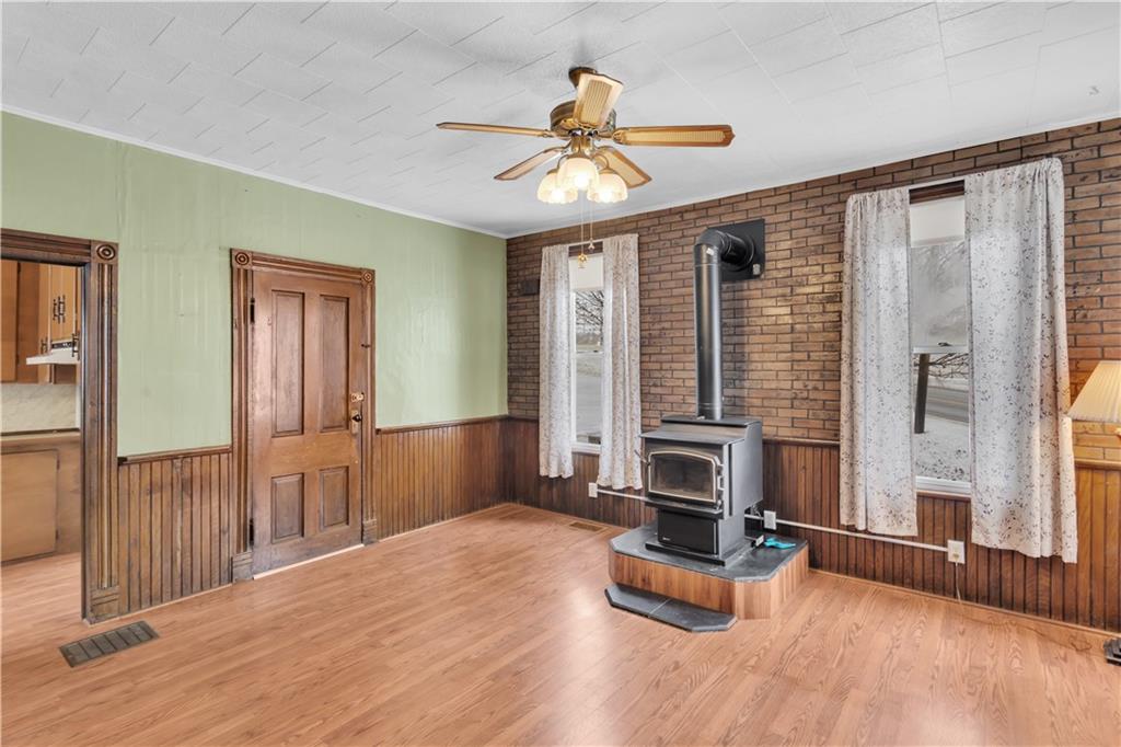 6656 Portersville Rd /state Rt 488 Portersville, PA 16051 - Photo 8 of 39 Original wainscoting and woodburner add warmth and texture to the kitchen and enhances the farmhouse feel.