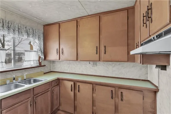 a kitchen with a sink and cabinets