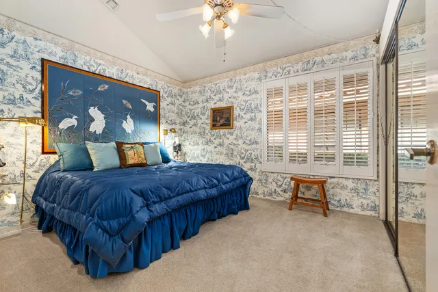 a bedroom with a bed and a table