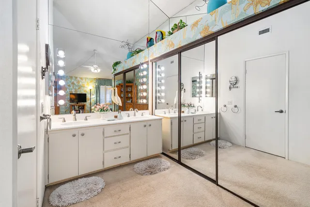 a bathroom with a double vanity sink and mirror