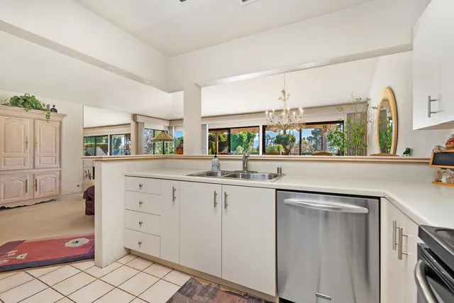 a kitchen with granite countertop a sink and cabinets
