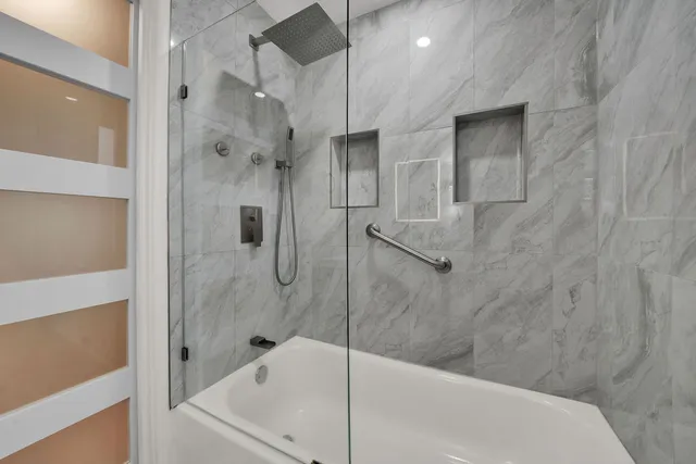 a bathroom with a bathtub and a shower