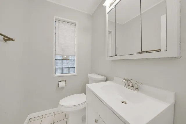 a bathroom with a sink toilet and mirror