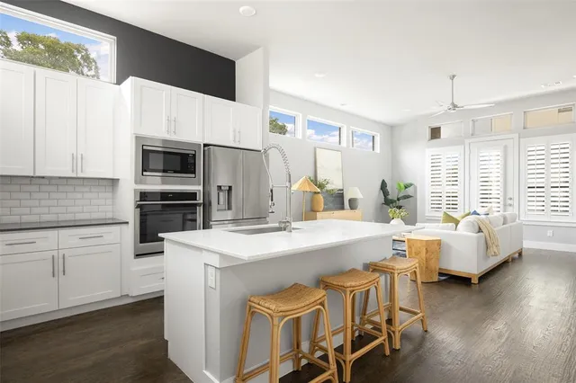 a kitchen with appliances a sink and cabinets