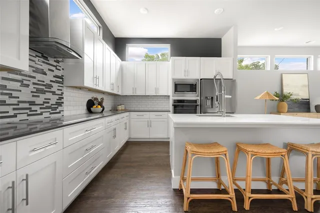 a kitchen with a sink cabinets and window