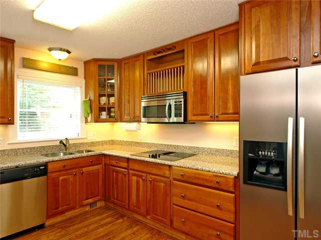 2509 Bedford Avenue Raleigh, NC 27607 - Photo 5 of 15 The gourmet kitchen has beautiful maple cabinets, some with glass doors and a pantry- tons of cabinet space! Enjoy the granite countertops, stainless steel appliances, smooth top cook top, built-in oven, under mount lighting and microwave!