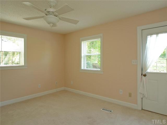 2509 Bedford Avenue Raleigh, NC 27607 - Photo 8 of 15 The master bedroom is in the back of the home off the kitchen and has a ceiling fan and 2 windows with door leading to the patio!