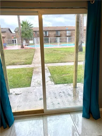 a view of a porch with a floor to ceiling window
