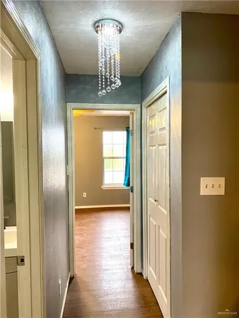 a view of a hallway with a chandelier