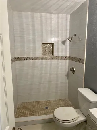 a bathroom with a toilet and a shower