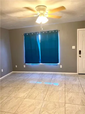 a view of a livingroom with a chandelier fan and a carpet