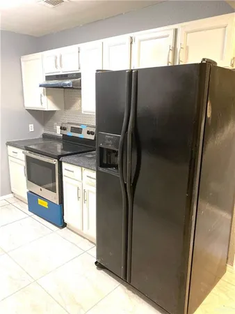 a kitchen with stainless steel appliances a refrigerator and a stove