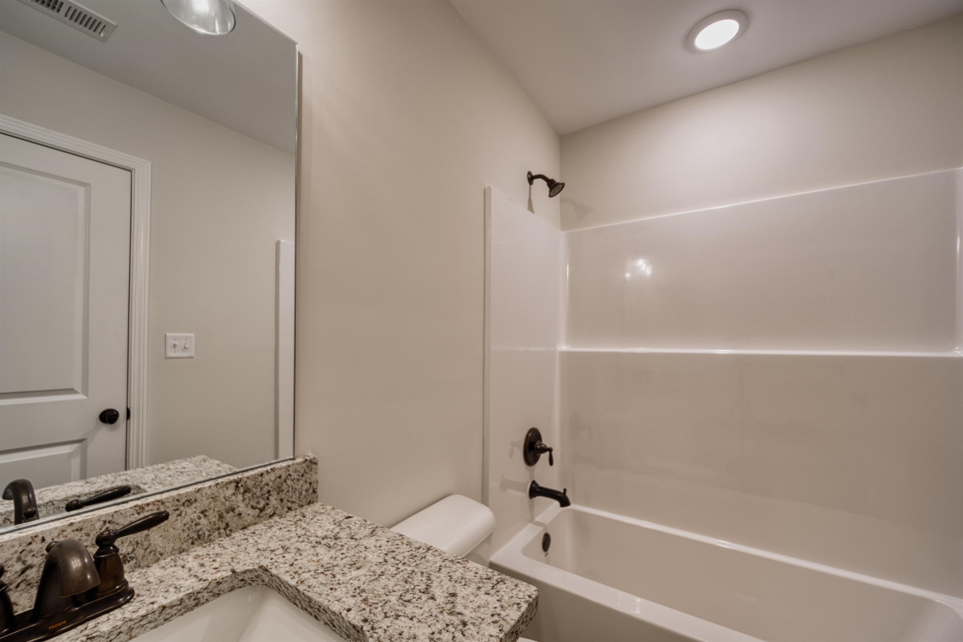 32 Forsyth Lane Munford, TN 38058 - Photo 11 of 35 a bathroom with a tub and a sink