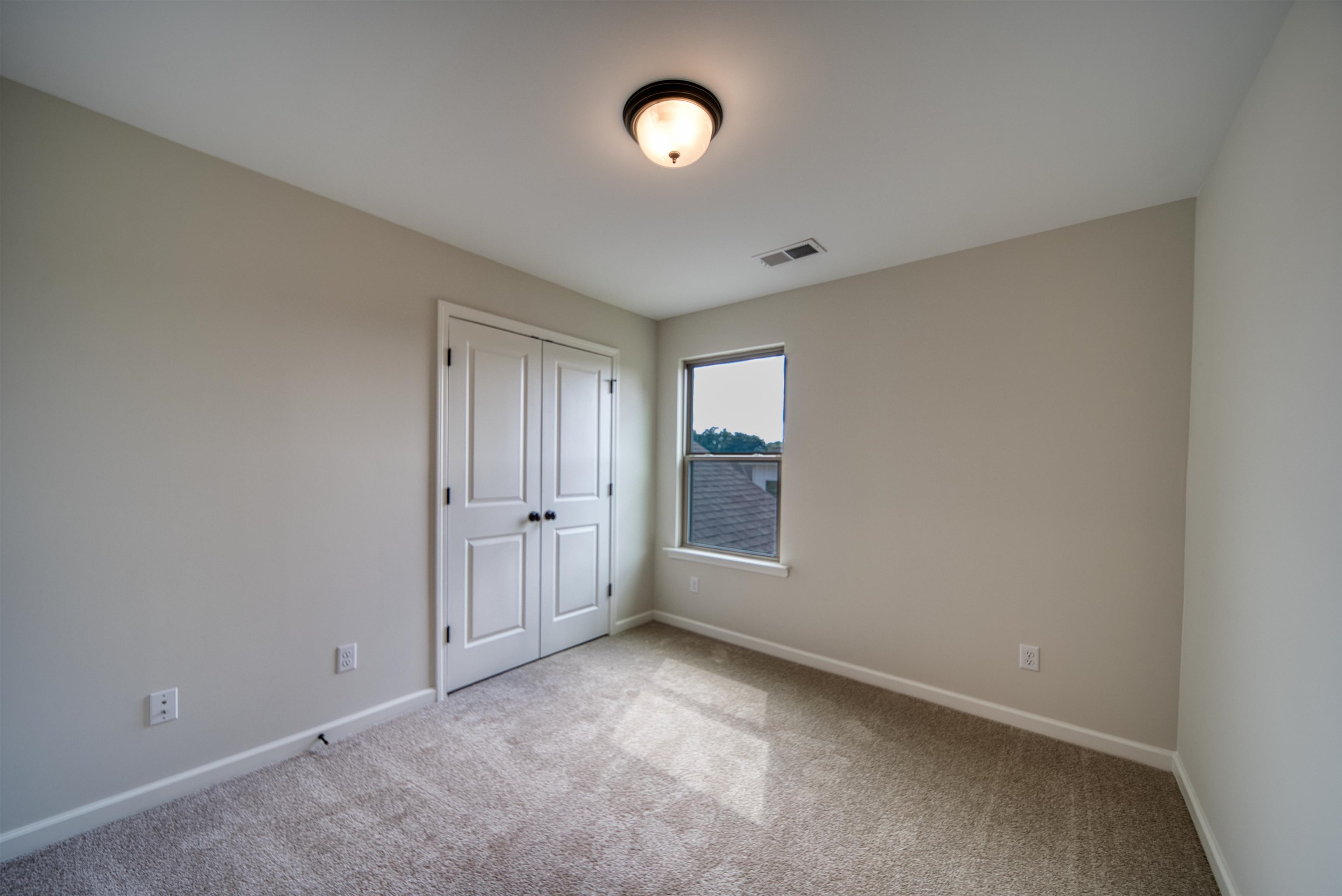 32 Forsyth Lane Munford, TN 38058 - Photo 12 of 35 a view of an empty room with a window and closet area