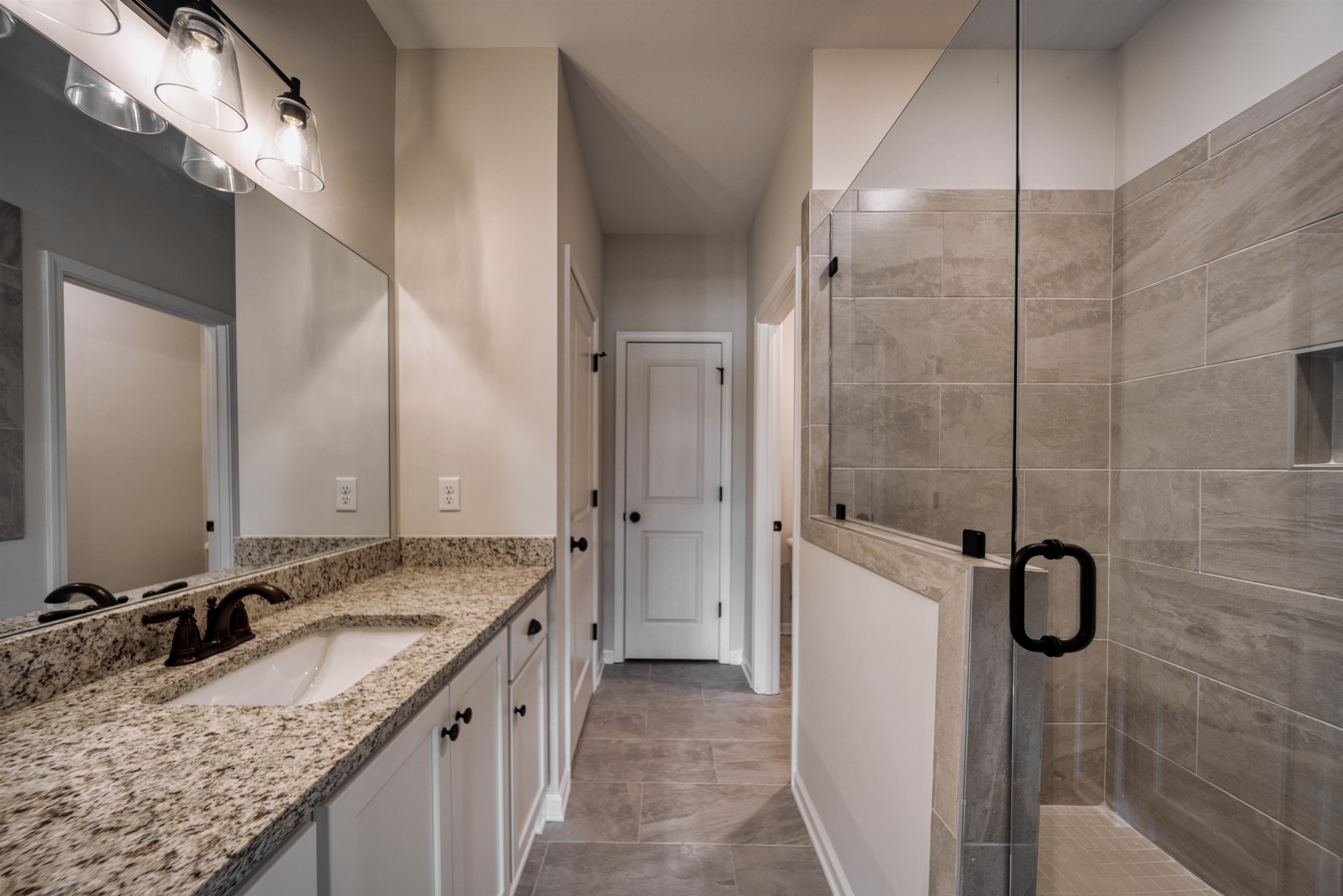 32 Forsyth Lane Munford, TN 38058 - Photo 25 of 35 a bathroom with a granite countertop sink and mirror
