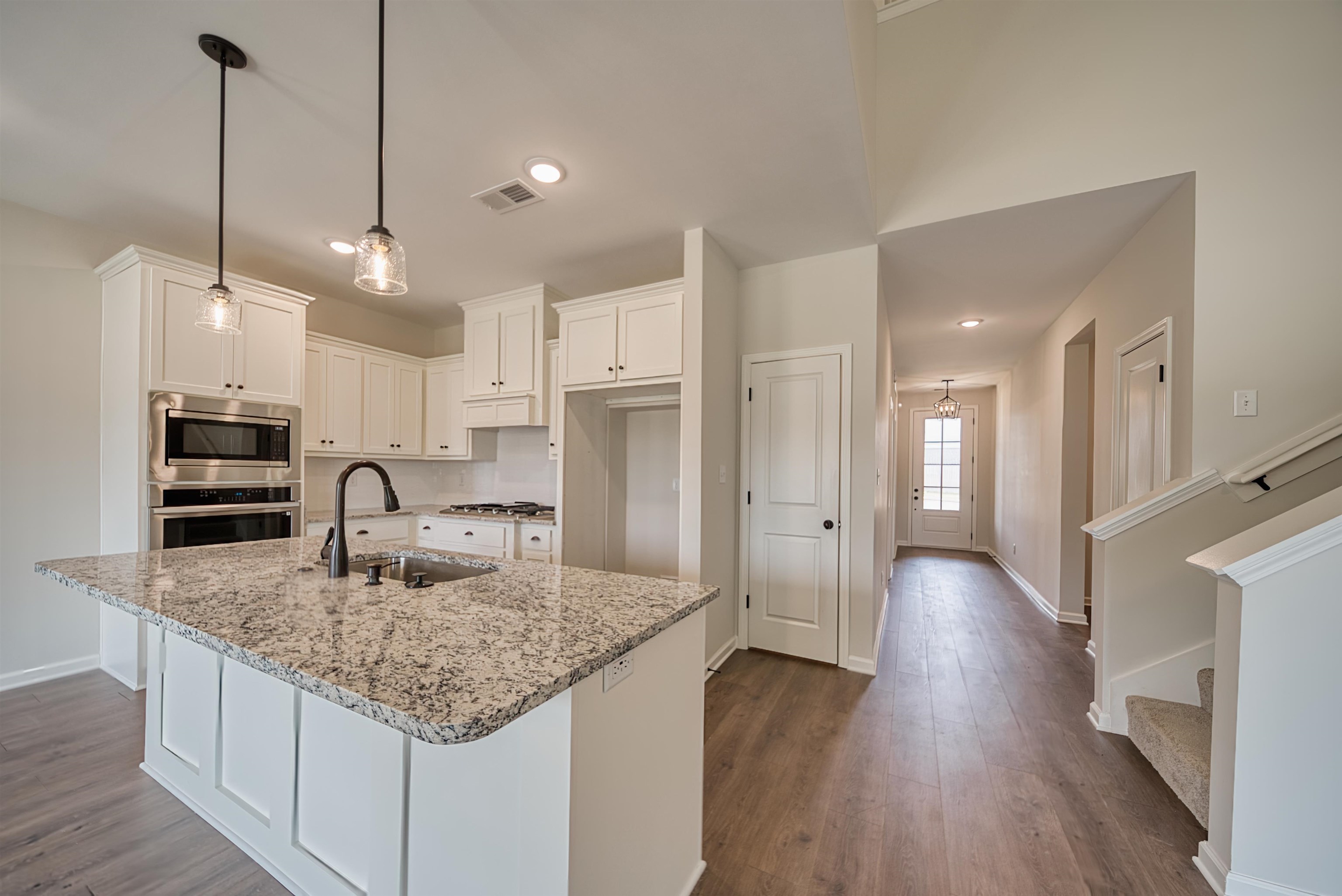 32 Forsyth Lane Munford, TN 38058 - Photo 3 of 35 a kitchen with kitchen island a counter top space a sink appliances and cabinets
