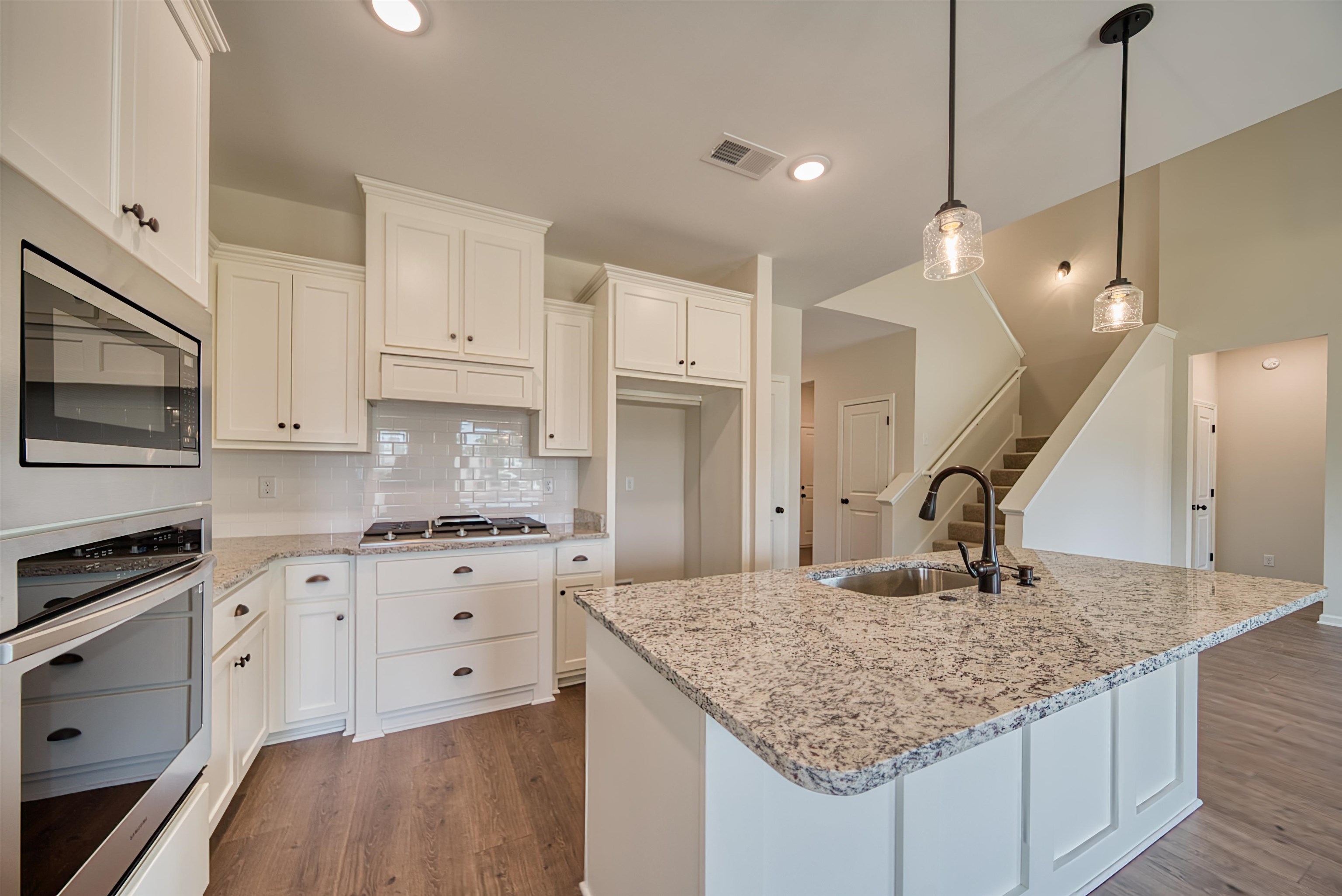 32 Forsyth Lane Munford, TN 38058 - Photo 4 of 35 a kitchen with stainless steel appliances granite countertop a sink stove and refrigerator
