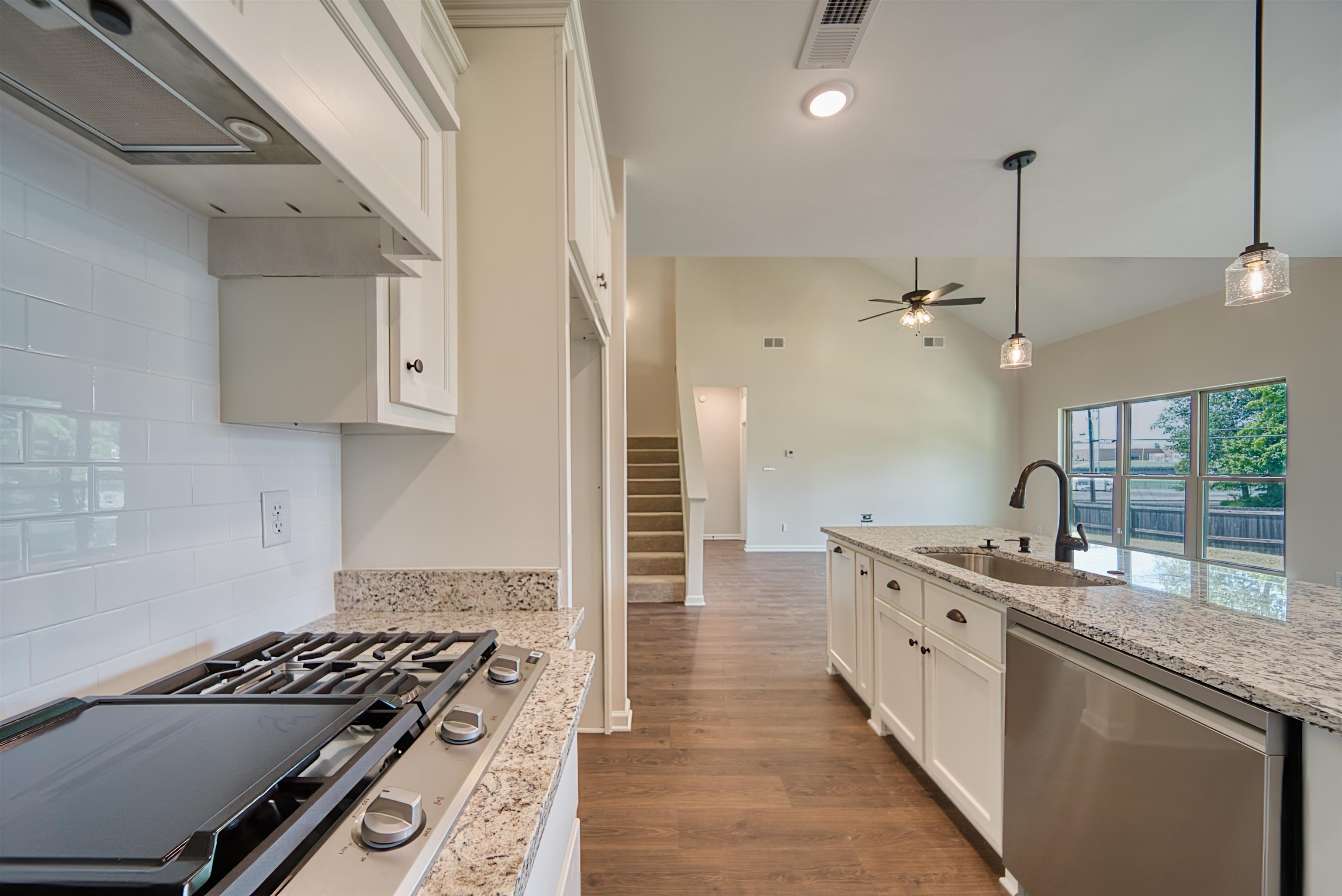 32 Forsyth Lane Munford, TN 38058 - Photo 6 of 35 a kitchen with granite countertop a sink stove and cabinets