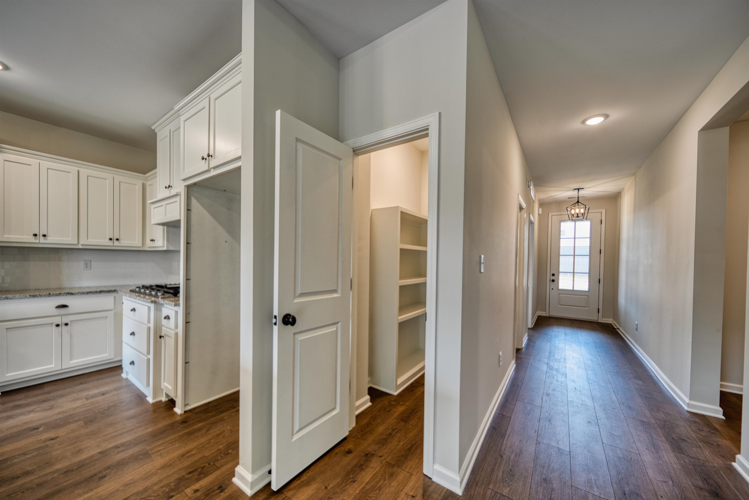 32 Forsyth Lane Munford, TN 38058 - Photo 7 of 35 a view of a kitchen with wooden floor and a refrigerator