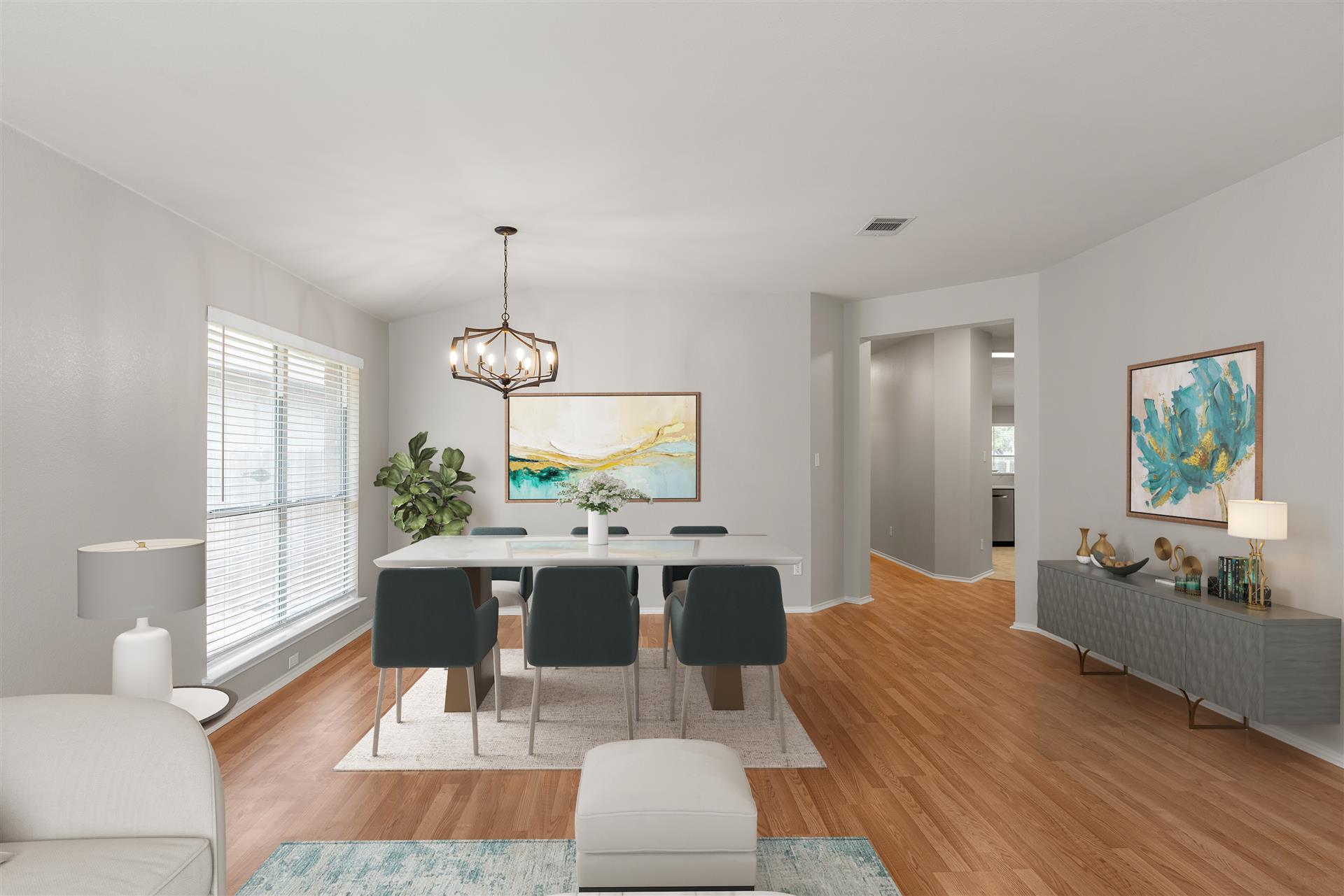 4725 Tello Path Austin, TX 78749 - Photo 5 of 34 Hardwood floors flow through this dining room, offering ample space for entertaining under a contemporary chandelier.