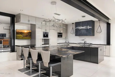 a kitchen with stainless steel appliances granite countertop a sink and a refrigerator