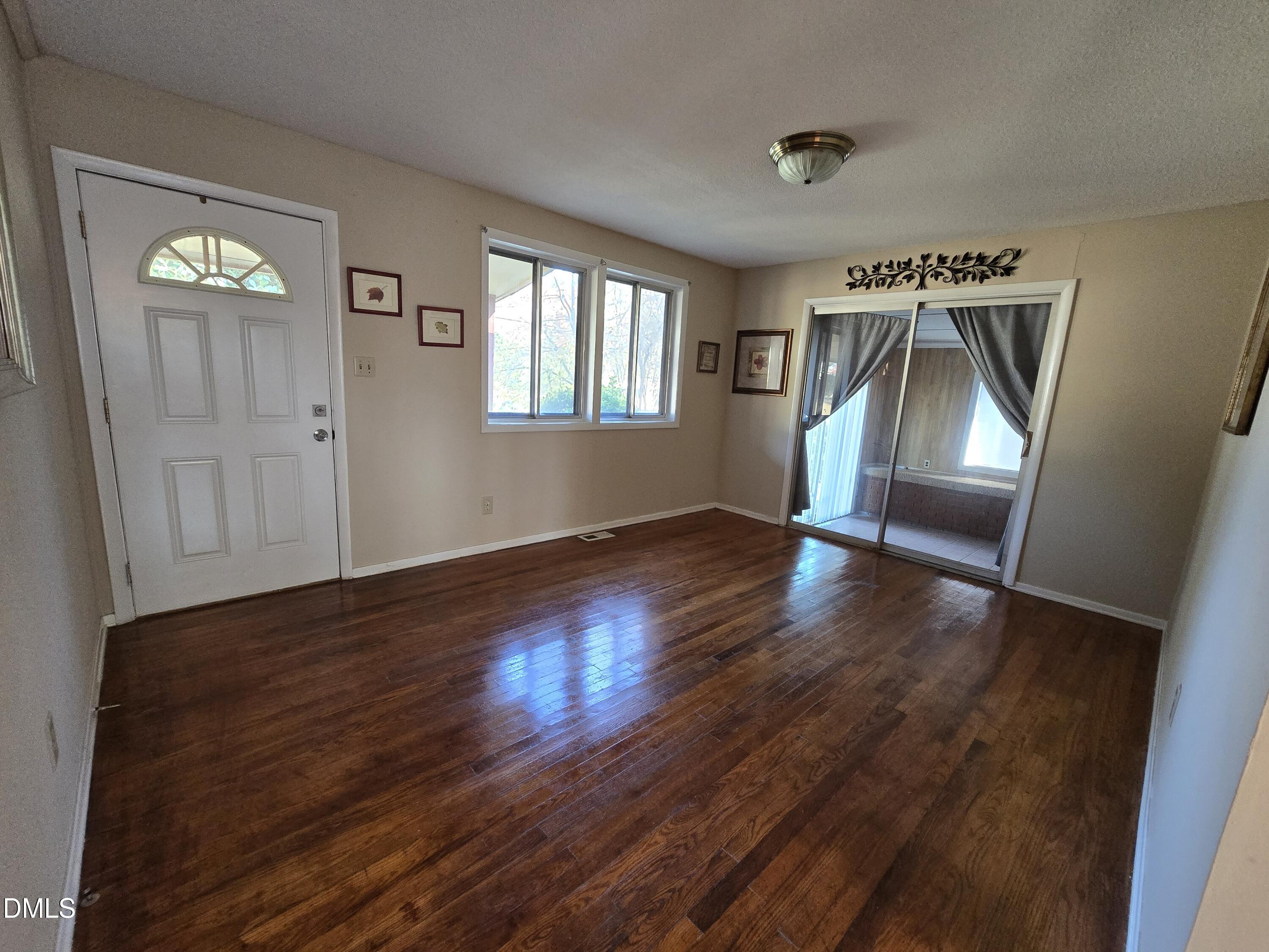 1808 Tee Dee Street Raleigh, NC 27610 - Photo 3 of 10 a view of empty room with wooden floor and fan
