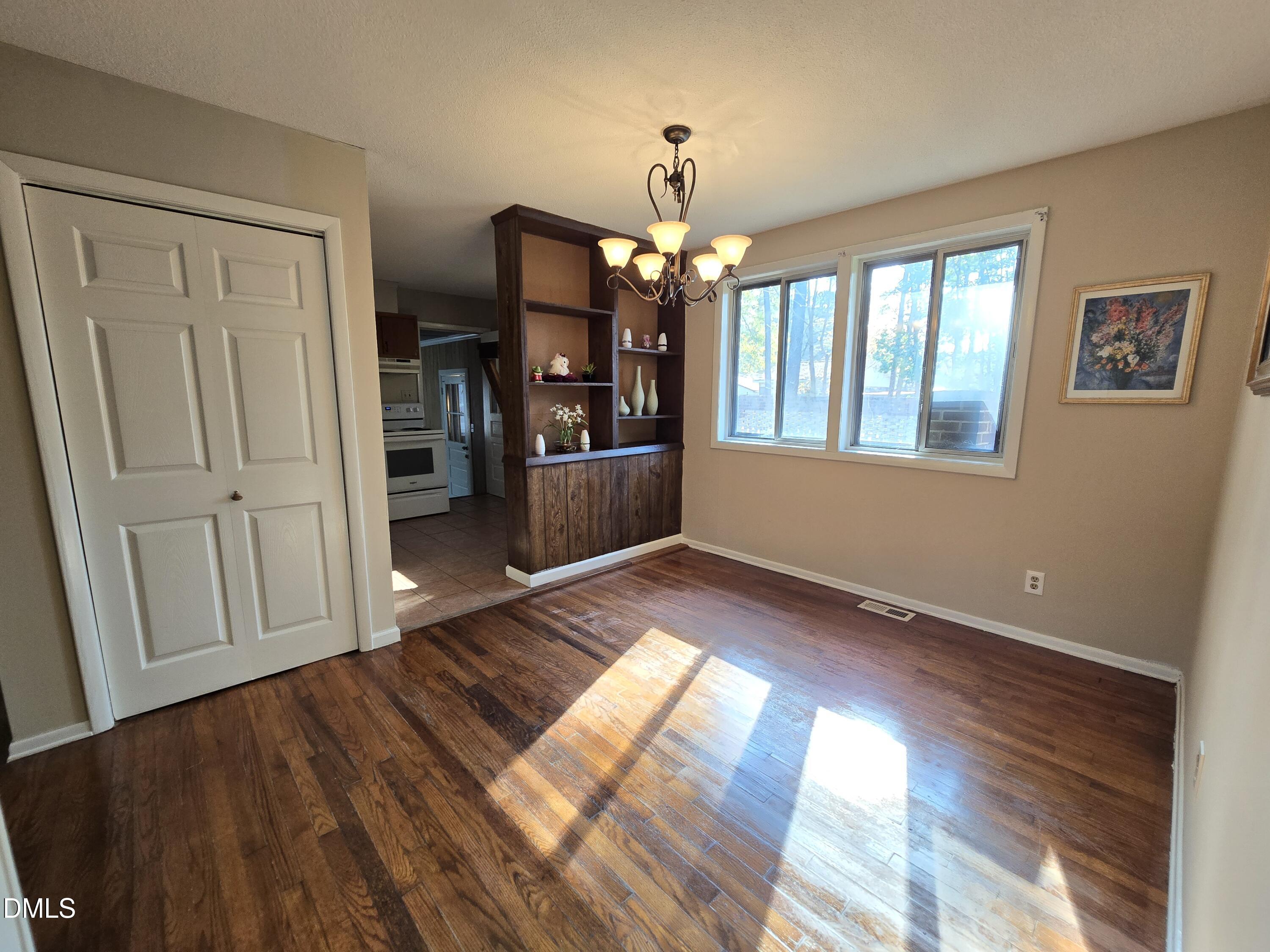 1808 Tee Dee Street Raleigh, NC 27610 - Photo 4 of 10 a view of empty room with wooden floor and fan