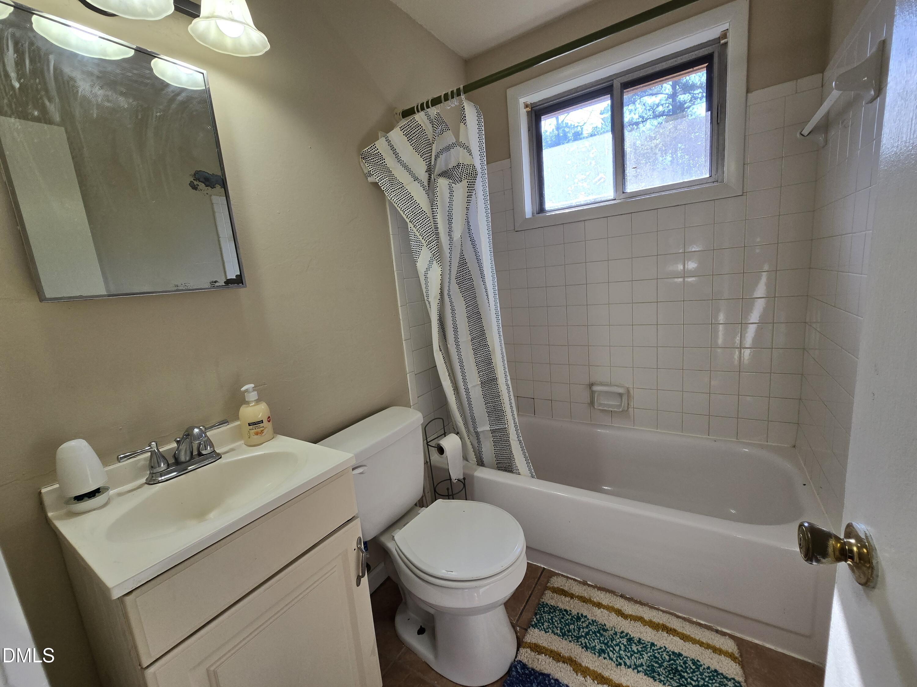 1808 Tee Dee Street Raleigh, NC 27610 - Photo 7 of 10 a bathroom with a sink toilet and shower