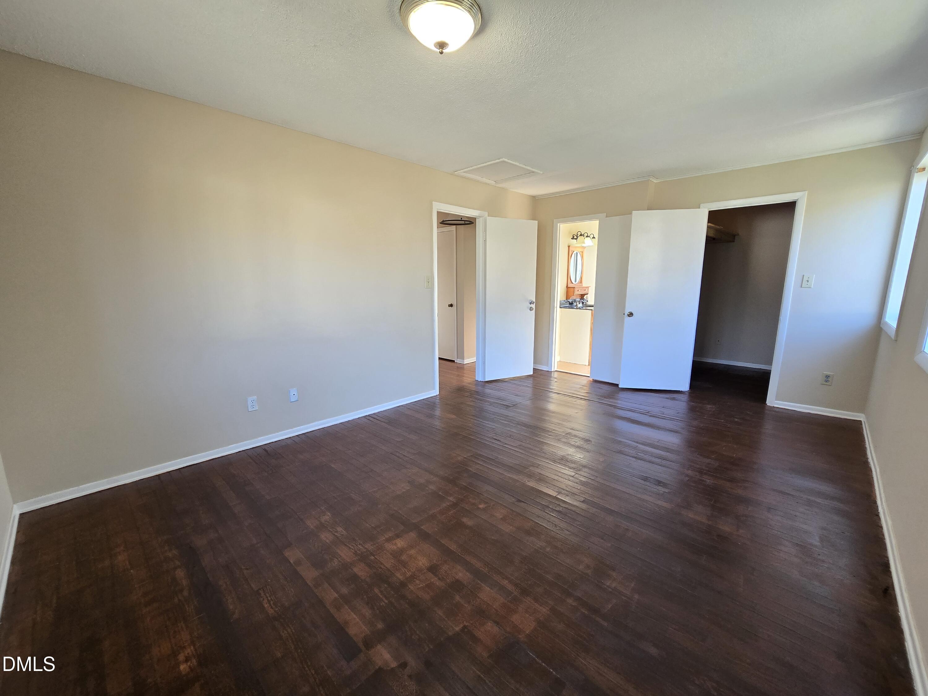 1808 Tee Dee Street Raleigh, NC 27610 - Photo 8 of 10 a view of an empty room with wooden floor and window
