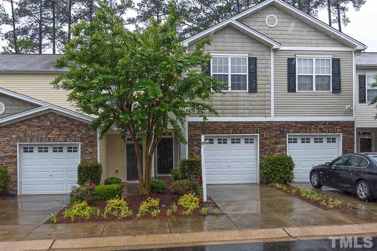 8249 Martello Lane Raleigh, NC 27613 - Photo 1 of 18 a view of a house with a yard and garage