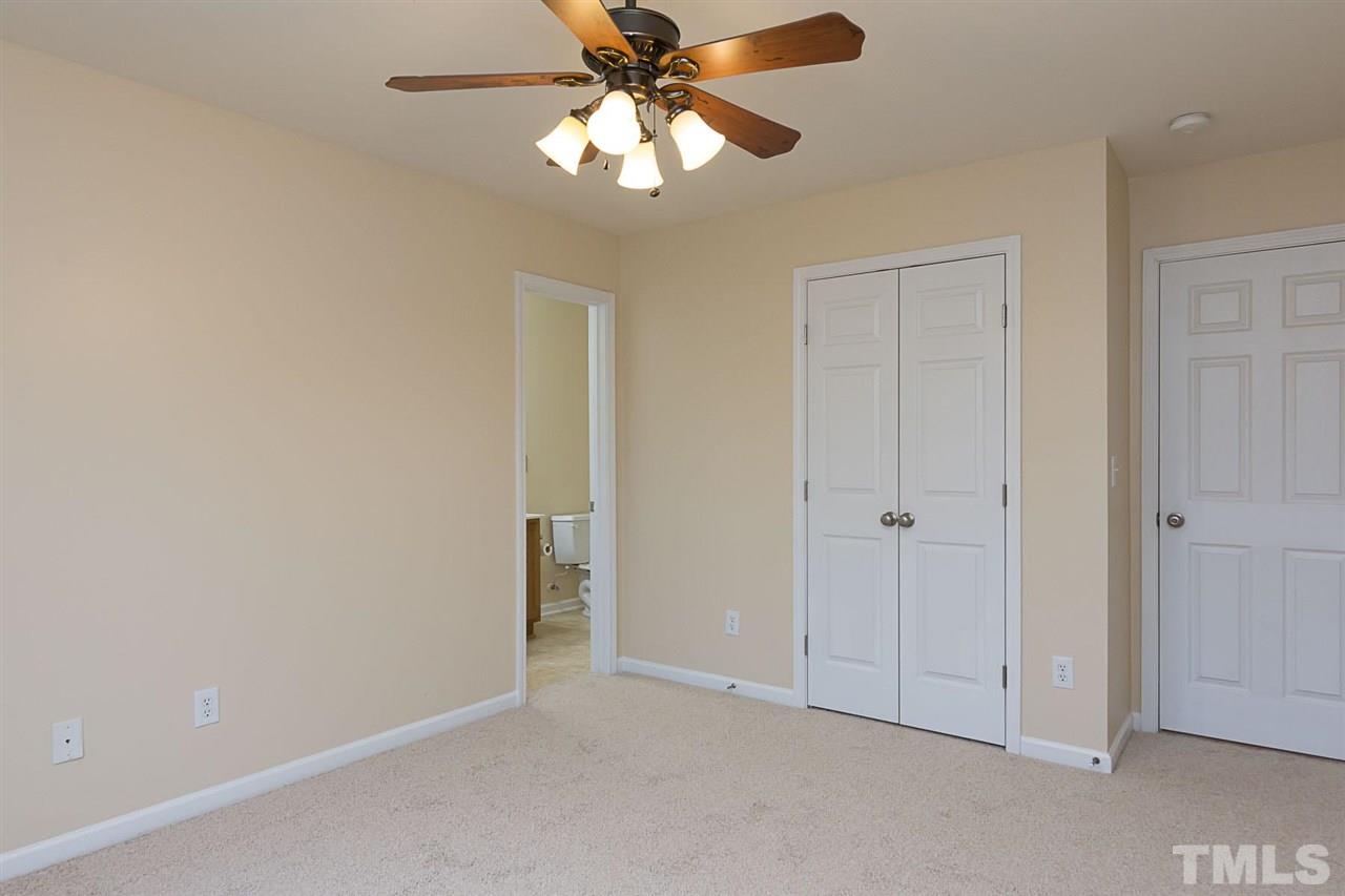 8249 Martello Lane Raleigh, NC 27613 - Photo 13 of 18 an empty room with closet and a chandelier fan