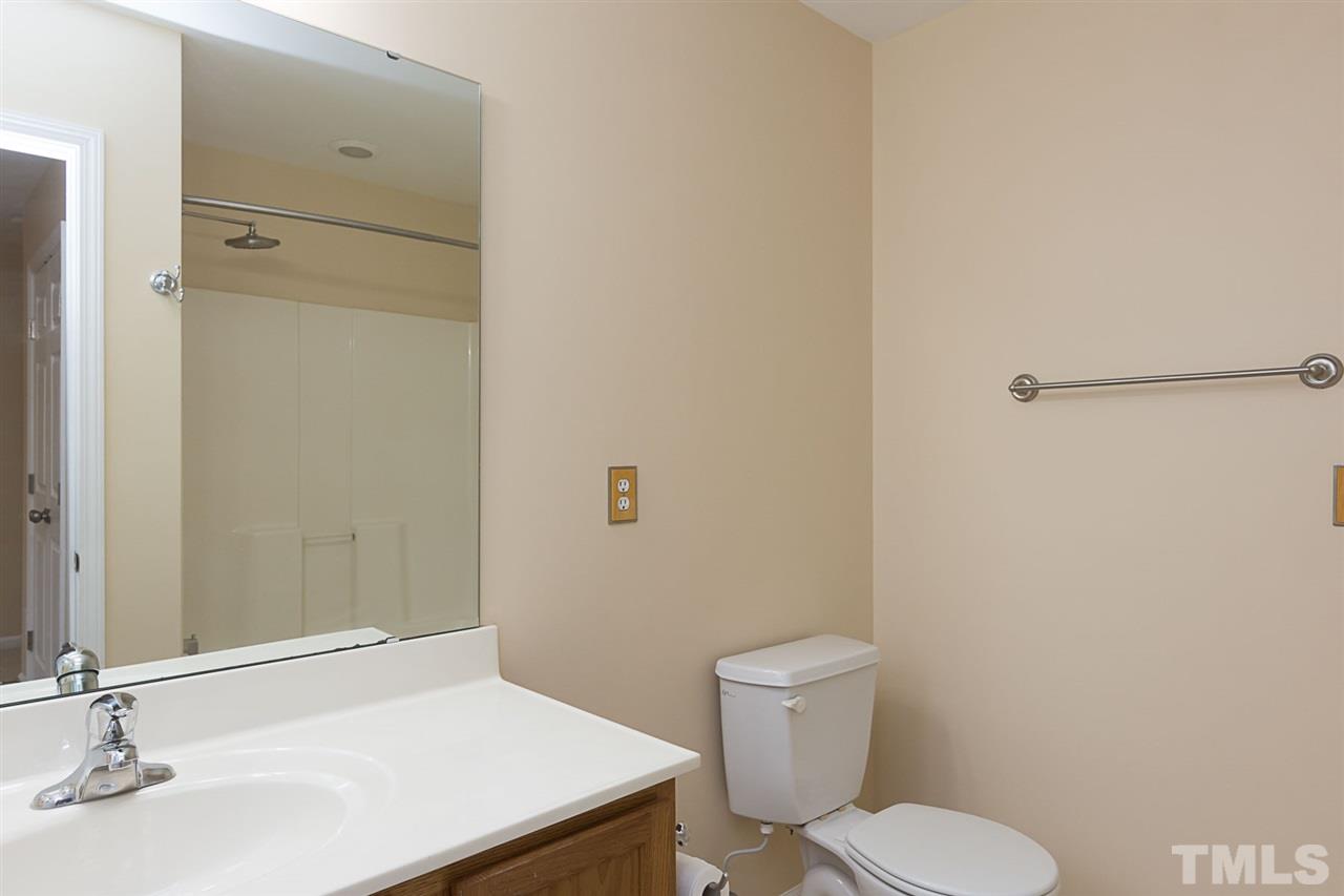 8249 Martello Lane Raleigh, NC 27613 - Photo 14 of 18 a bathroom with a sink a toilet and shower