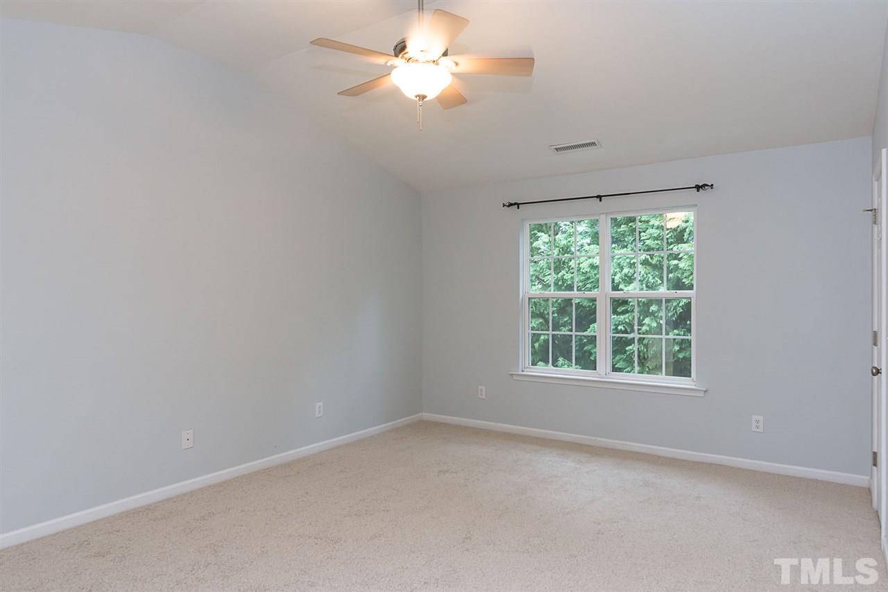 8249 Martello Lane Raleigh, NC 27613 - Photo 15 of 18 an empty room with a window and a fan