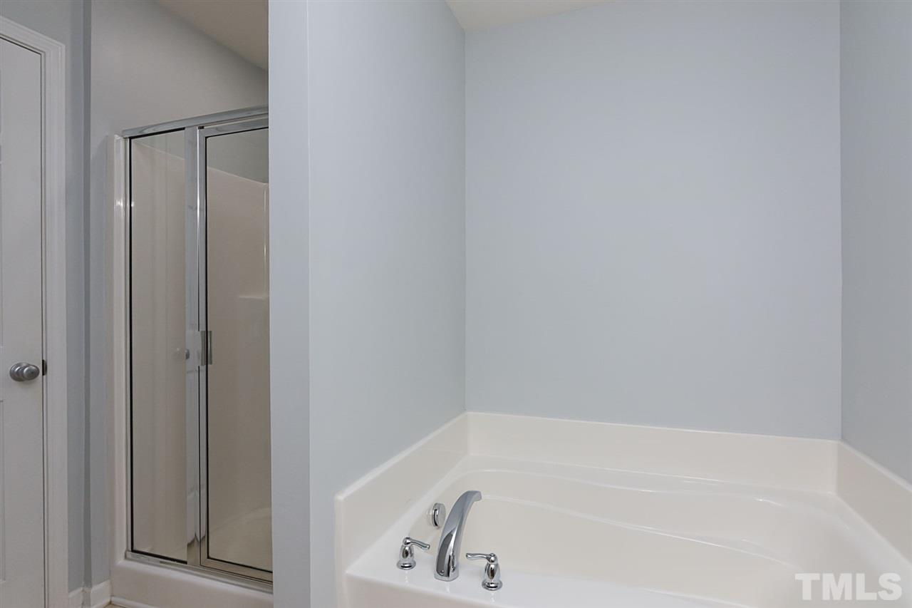 8249 Martello Lane Raleigh, NC 27613 - Photo 18 of 18 a bathroom with bathtub and shower