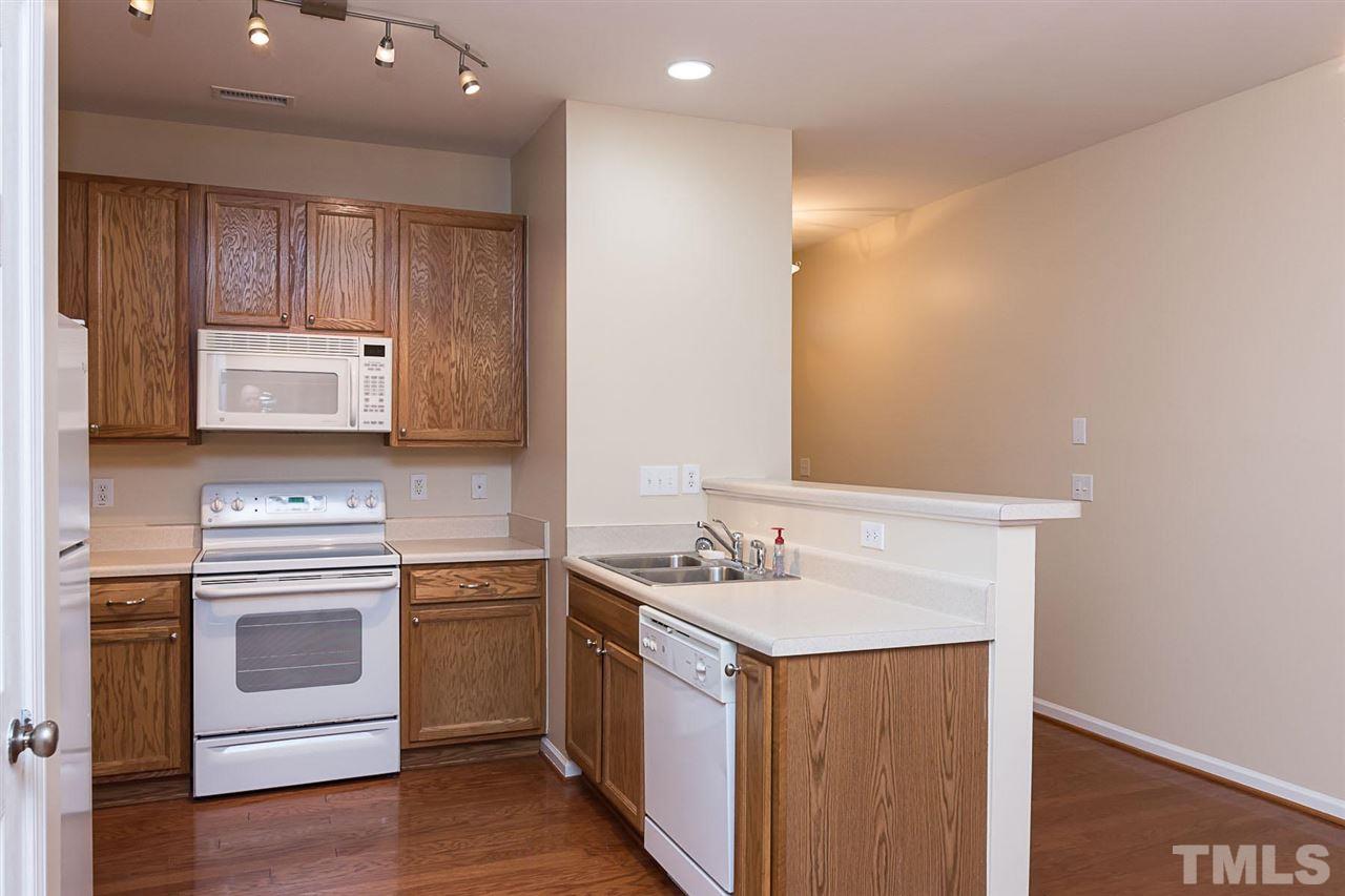 8249 Martello Lane Raleigh, NC 27613 - Photo 5 of 18 a kitchen with a sink stove and microwave