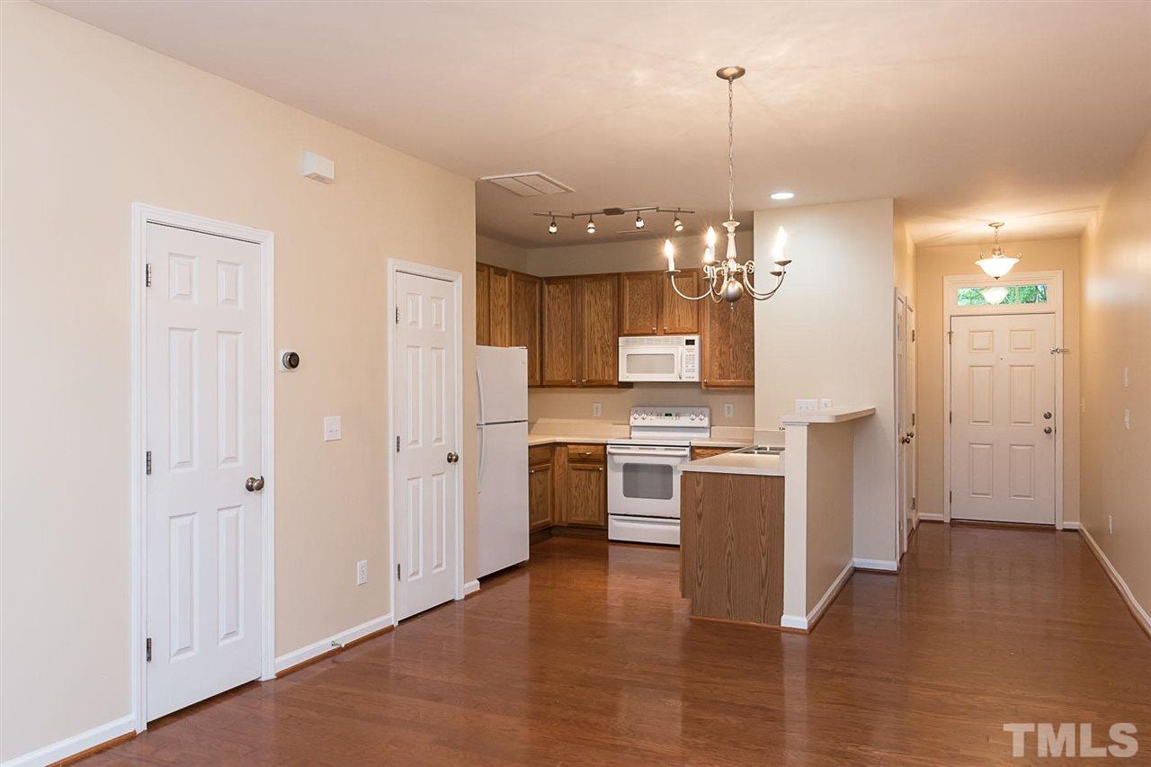 8249 Martello Lane Raleigh, NC 27613 - Photo 8 of 18 a kitchen with a refrigerator and cabinets