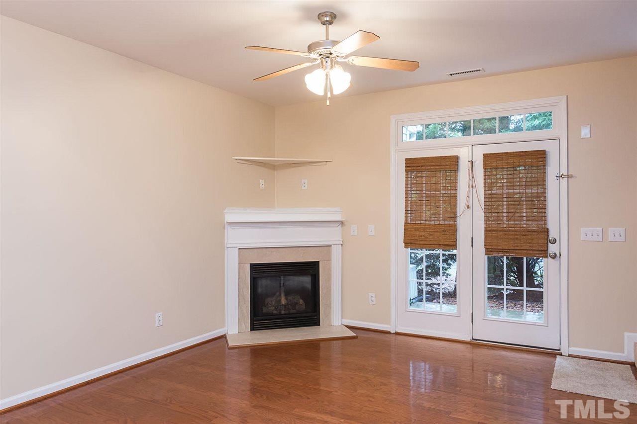 8249 Martello Lane Raleigh, NC 27613 - Photo 10 of 18 an empty room with windows and fireplace