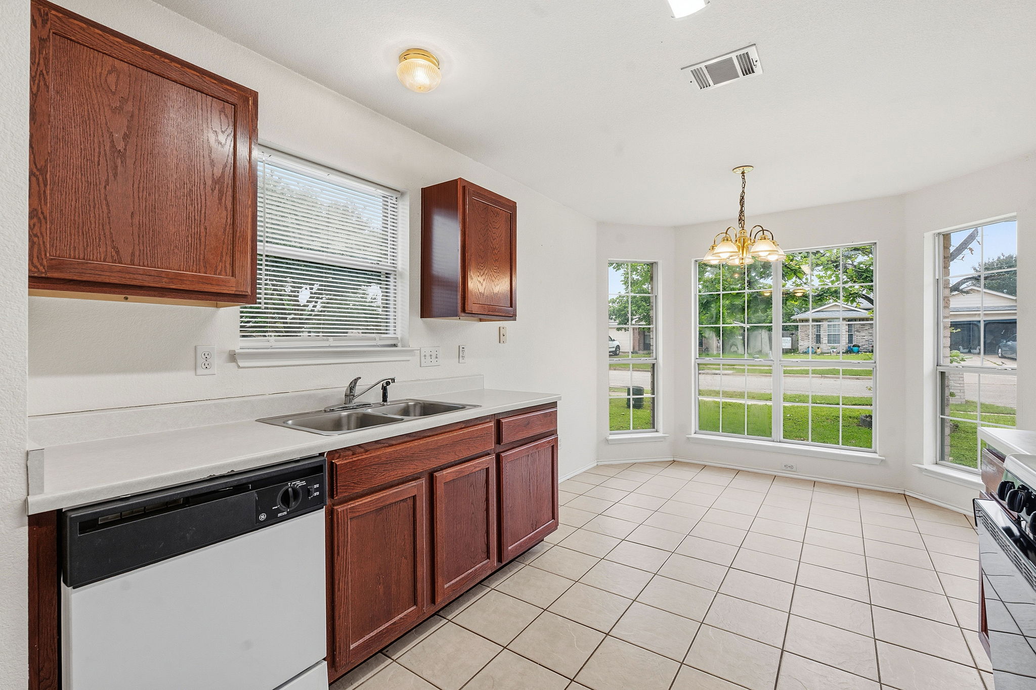 116 Blue Ridge Trail Elgin, TX 78621 - Photo 9 of 28 a kitchen with a sink stove and cabinets