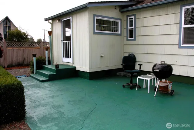 a backyard of a house with table and chairs