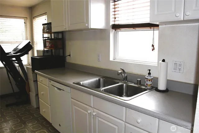 a kitchen with stainless steel appliances a stove a sink and a refrigerator