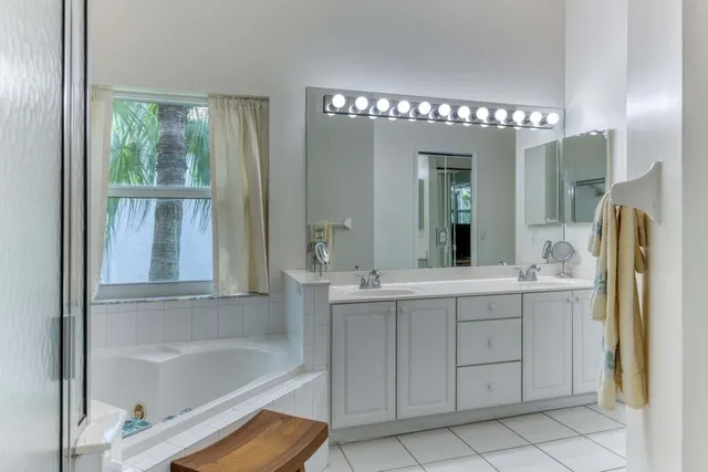 a bathroom with a bathtub sink and mirror