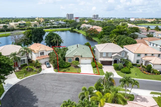 an aerial view of a house with a garden and lake view