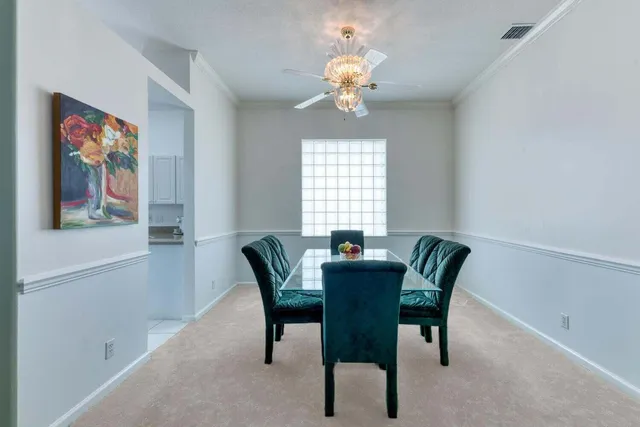 a view of a dining room with furniture and chandelier