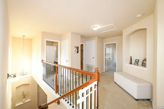 a view of a hallway with a livingroom and a bathtub