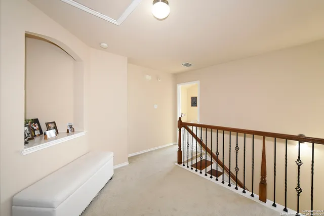 a hallway with white cabinets