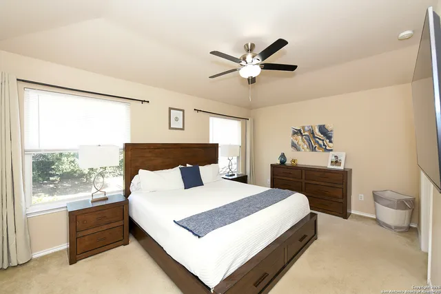 a bedroom with a large bed and a window