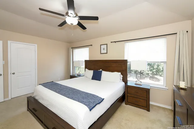 a bedroom with a large bed and a window