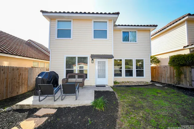 a view of a house with backyard sitting area and porch