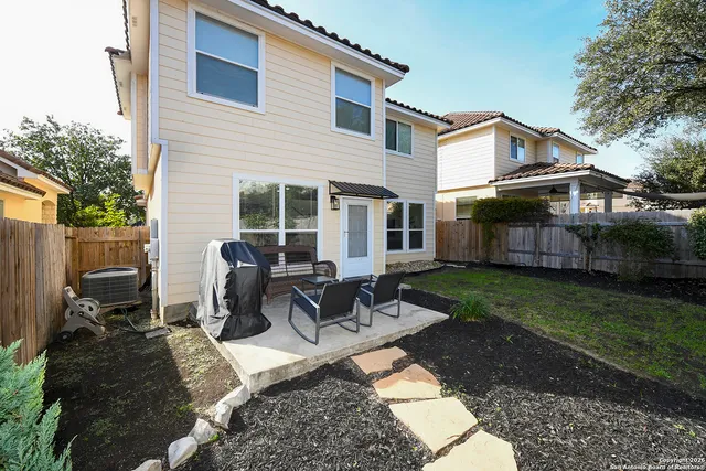 a view of a house with backyard and sitting area
