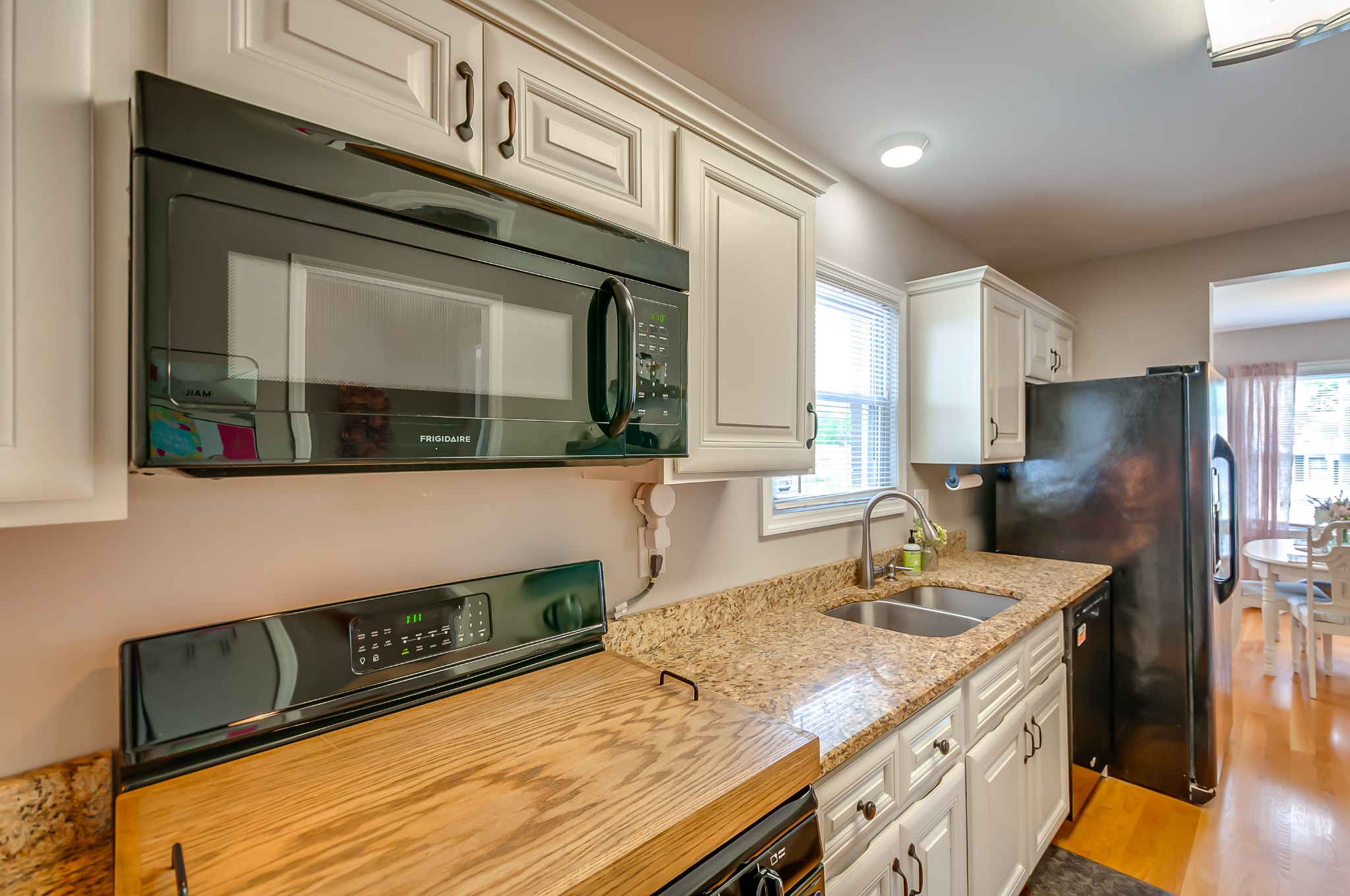 431 Maple Street Madison, TN 37115 - Photo 13 of 42 a kitchen with stainless steel appliances granite countertop a sink a stove and a microwave